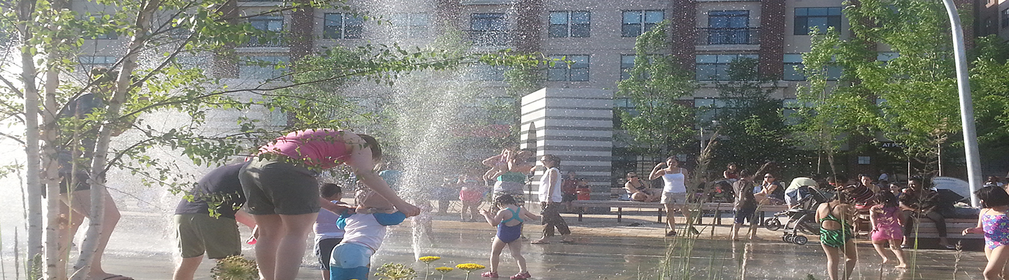 Kids playing in a fountain in front of apartments. Photo Credit: U.S. Environmental Protection Agency.