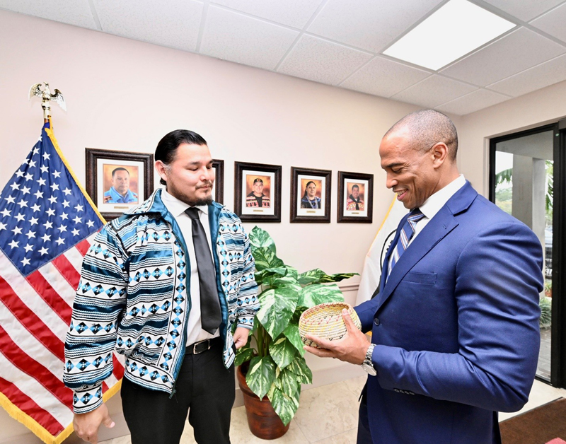 NLC Deputy Director, Kyle Doney, presents a hand-made Seminole basket to Secretary Turner. NLC Deputy Director, Kyle Doney, presents a hand-made Seminole basket to Secretary Turner.