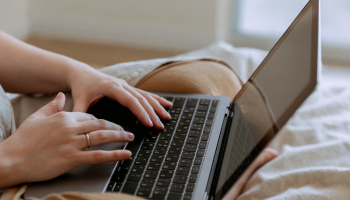 Hand typing on a computer